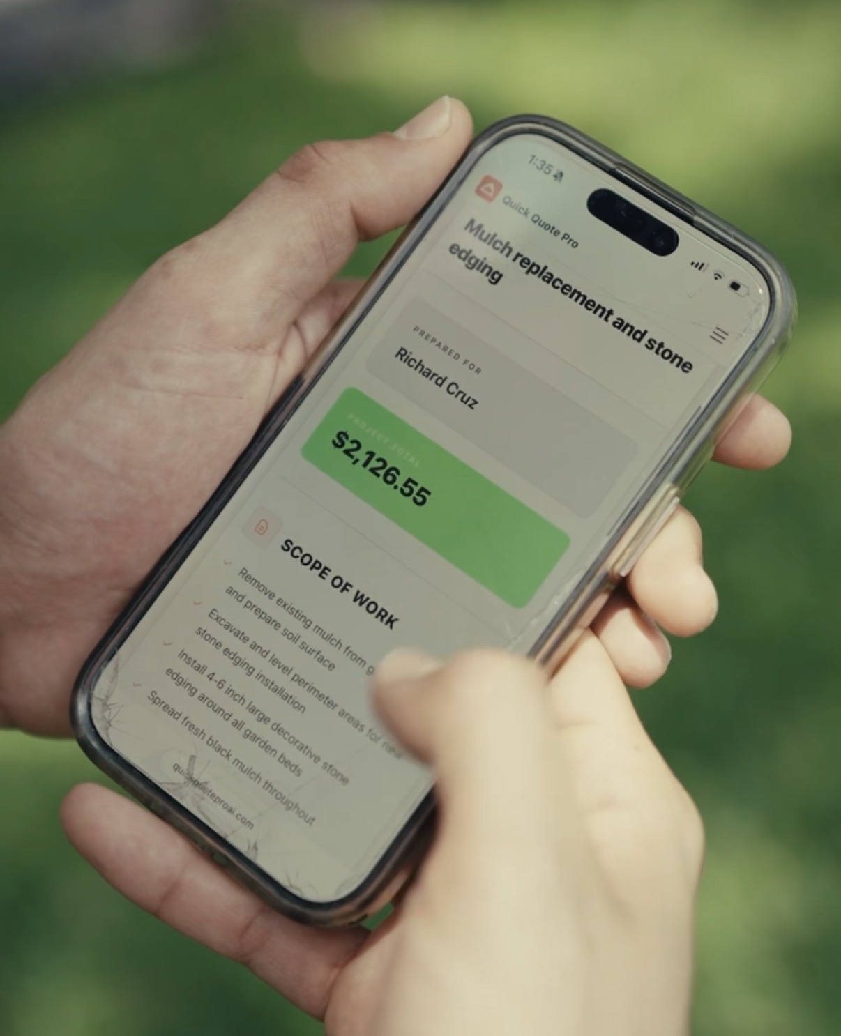 A contractor on a job site holding a phone showing a Quick Quote Pro proposal — $2,126.55 with scope of work